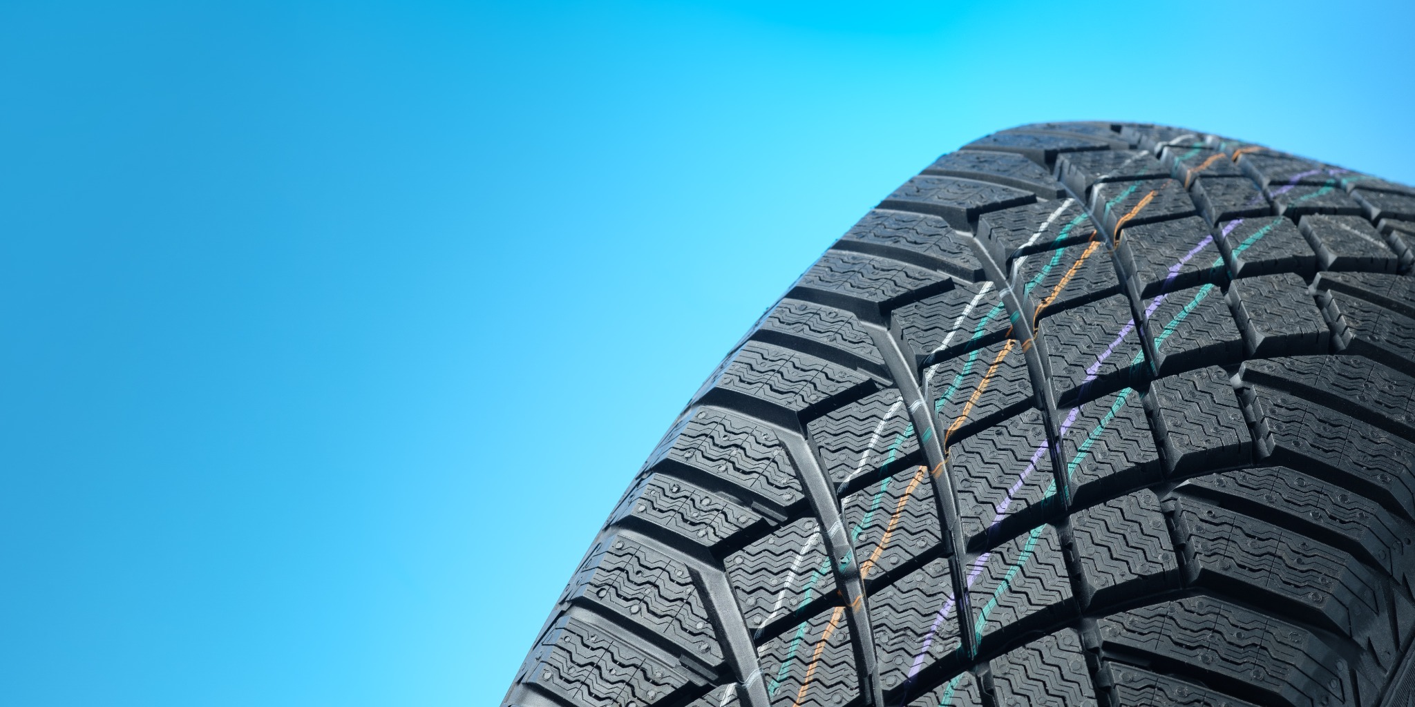 Winter tire on blue background