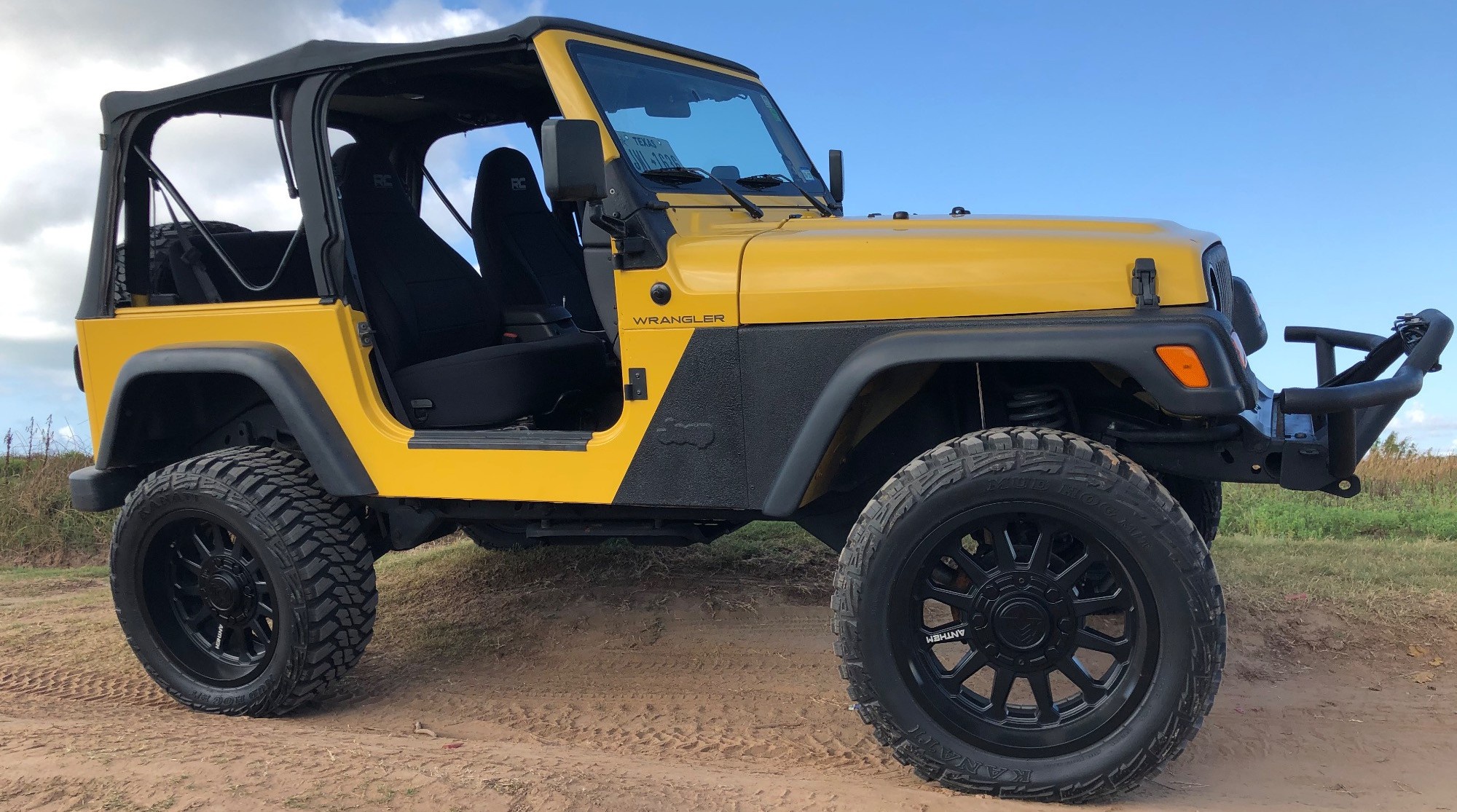 profile view of yellow jeep wrangler